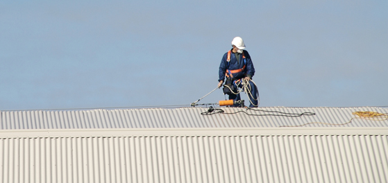 Roofer fixing metal roof